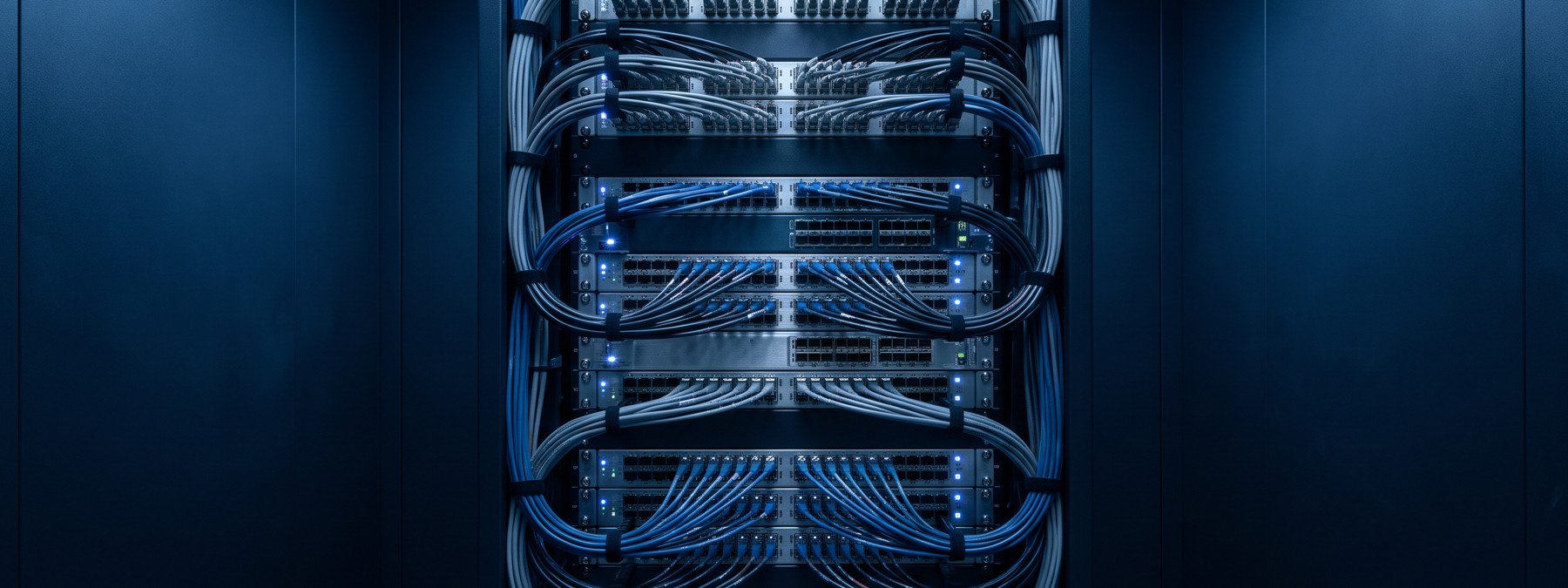 A network rack of neatly dressed cabling and rows of ports: the physical fabric that connects addresses and devices.